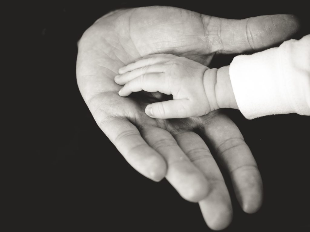 A baby hand and newborn baby activities