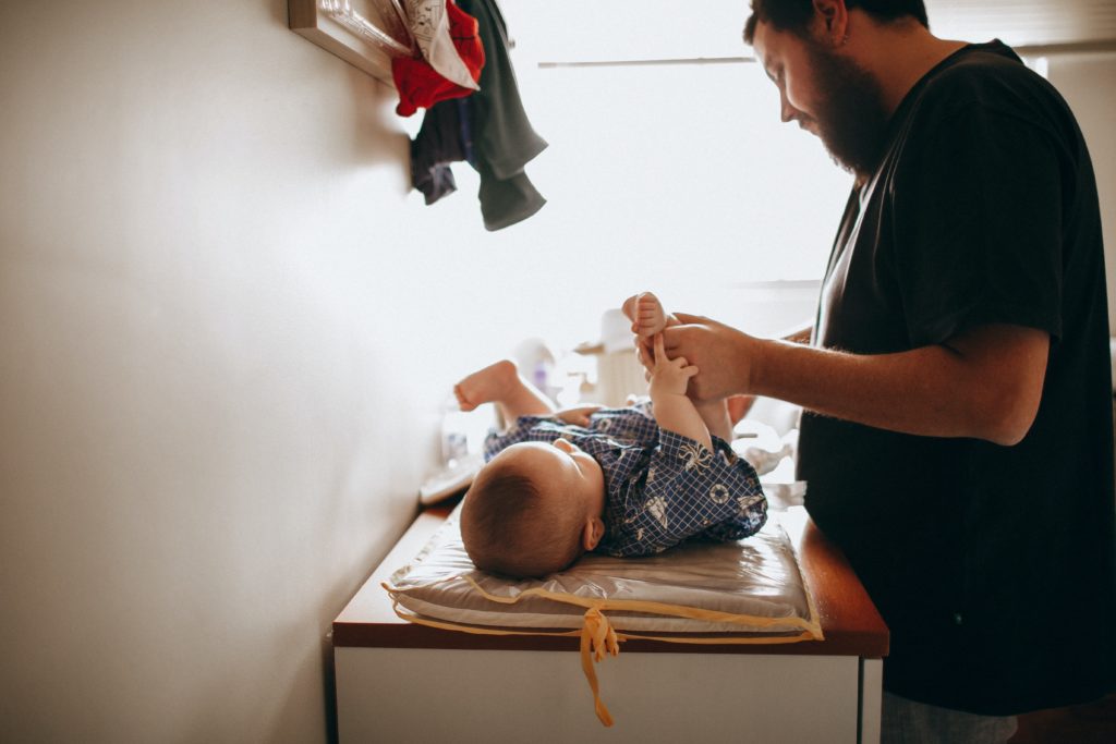 dad changing newborn blowout baby