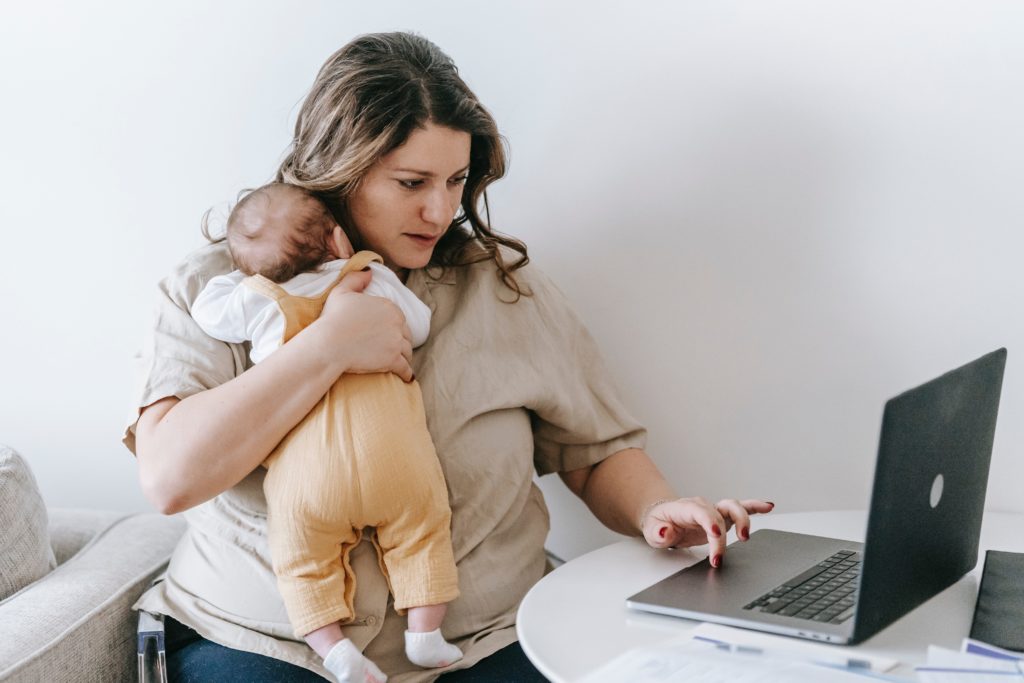 A woman concerned that her infant has an RSV virus looking up info on her computer