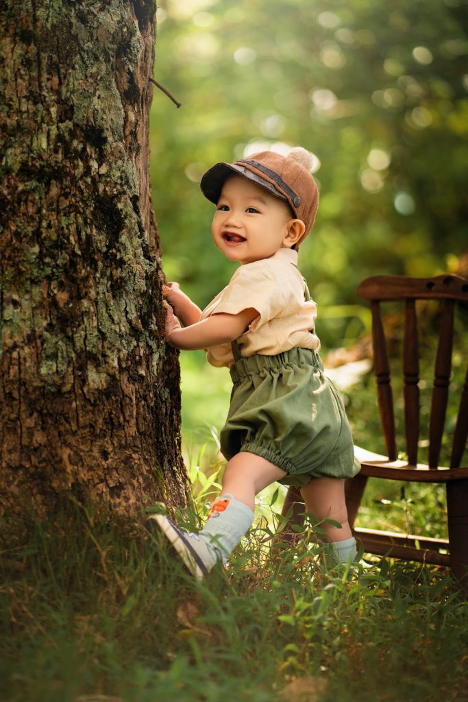A baby outdoors with a cap on. What is cradle cap
