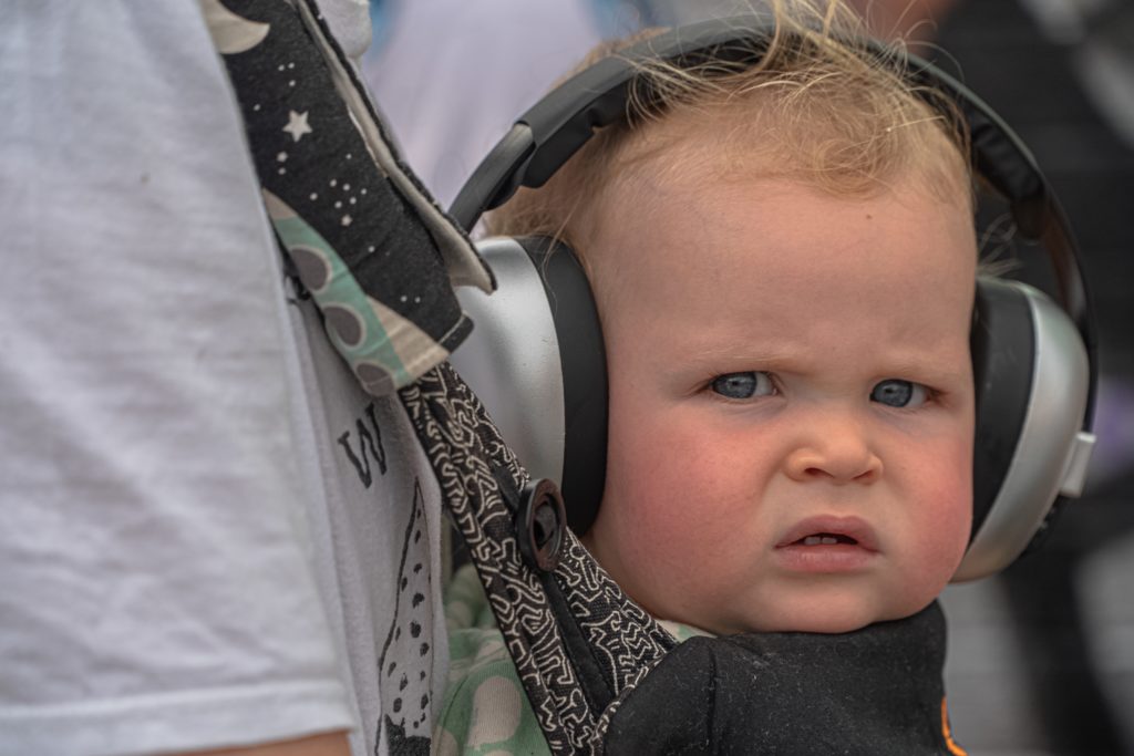 a photo of a baby with headphones on at a baby concert