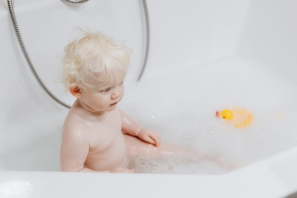A baby in a tub, how to give your baby a bath