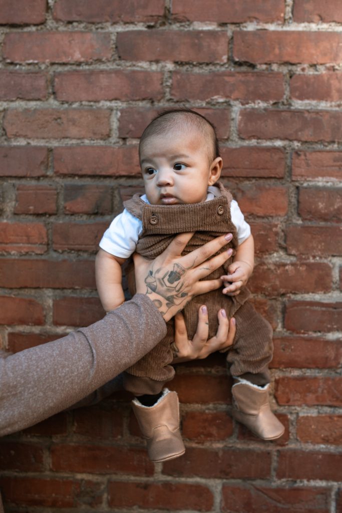A photo of a baby on a brick wall and Diarrhea in babies can be a distressing and concerning experience for parents