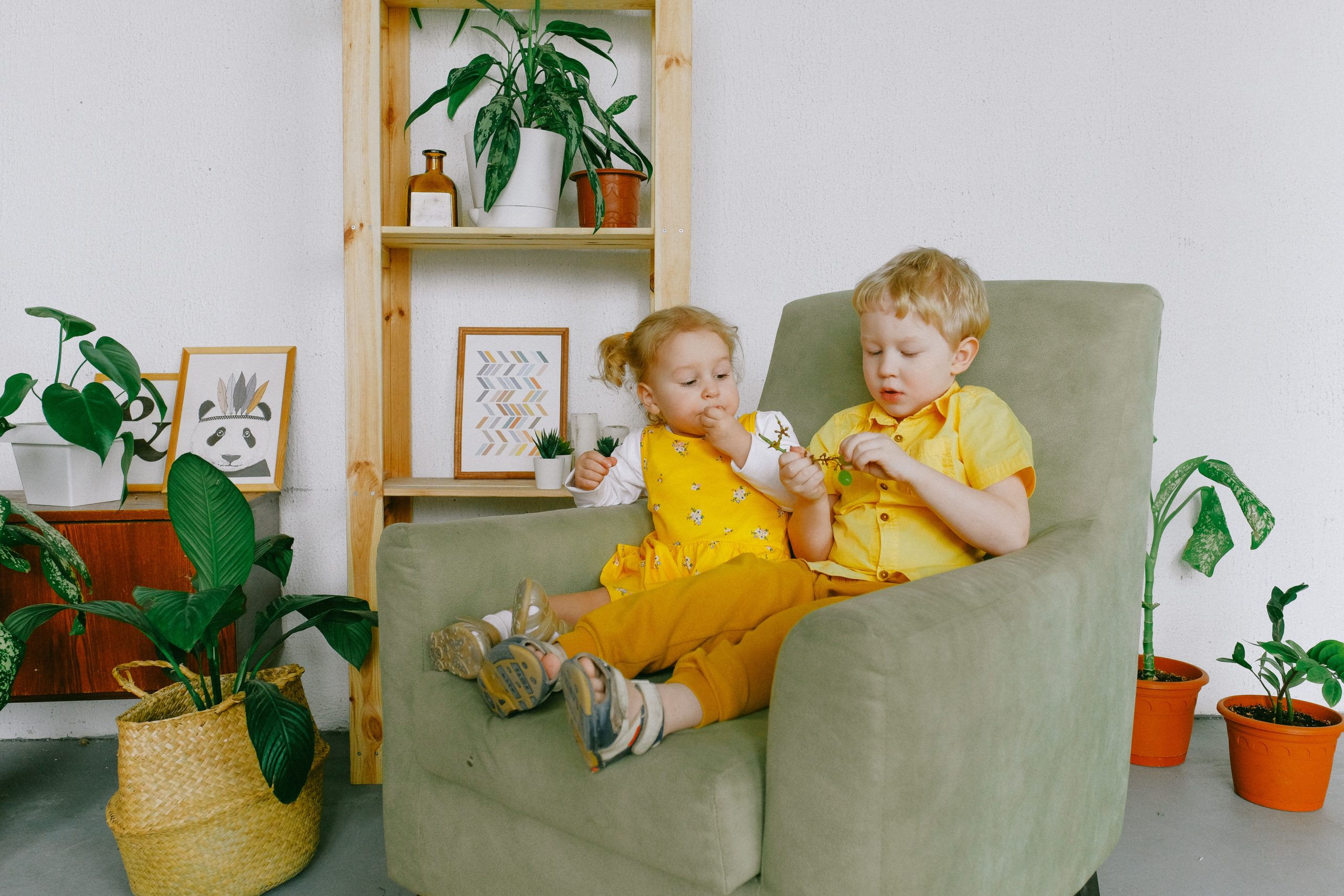 A baby and a toddler eating Baby Snacks