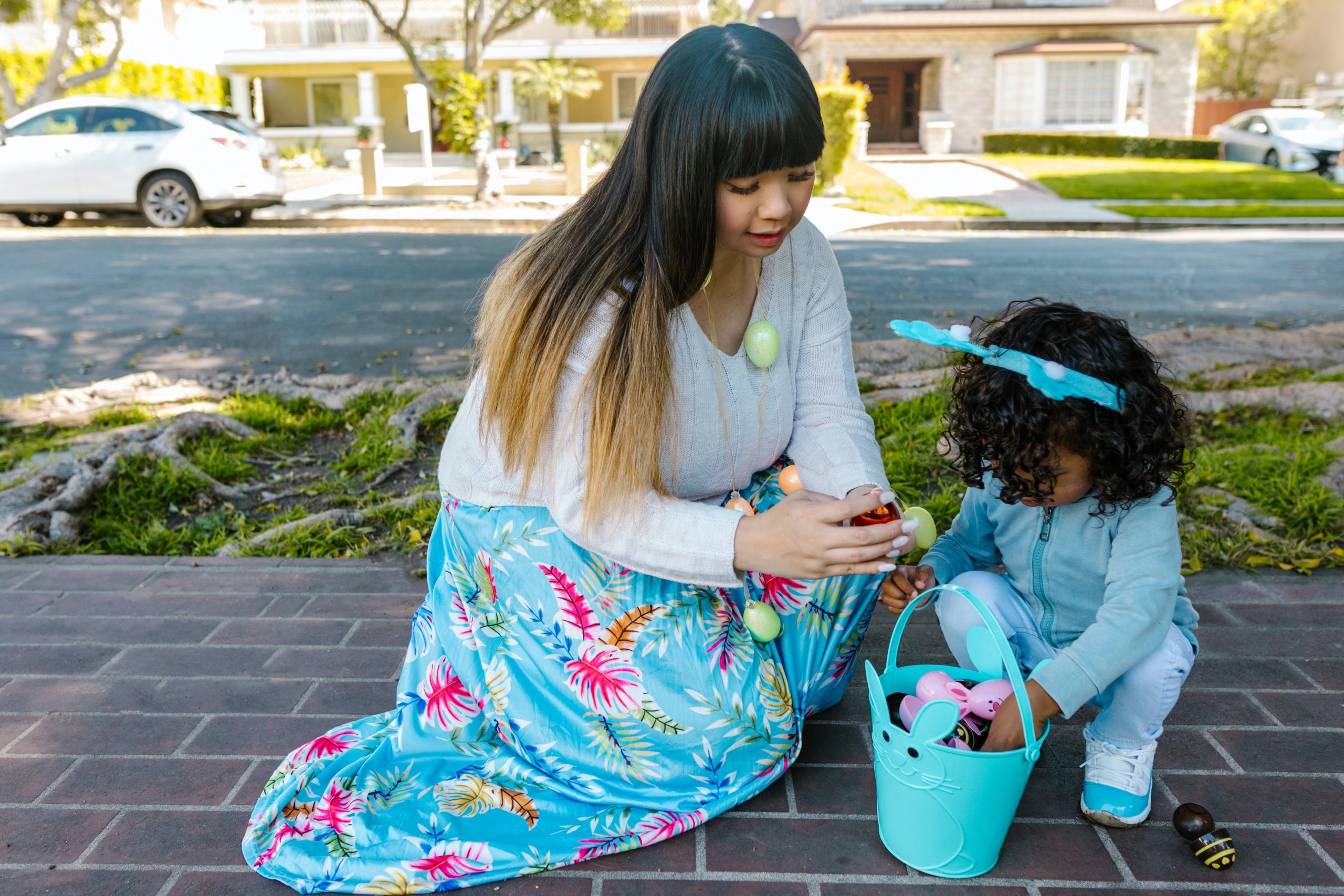 A mom and toddler looking for easter eggs. Easter gifts for toddlers.