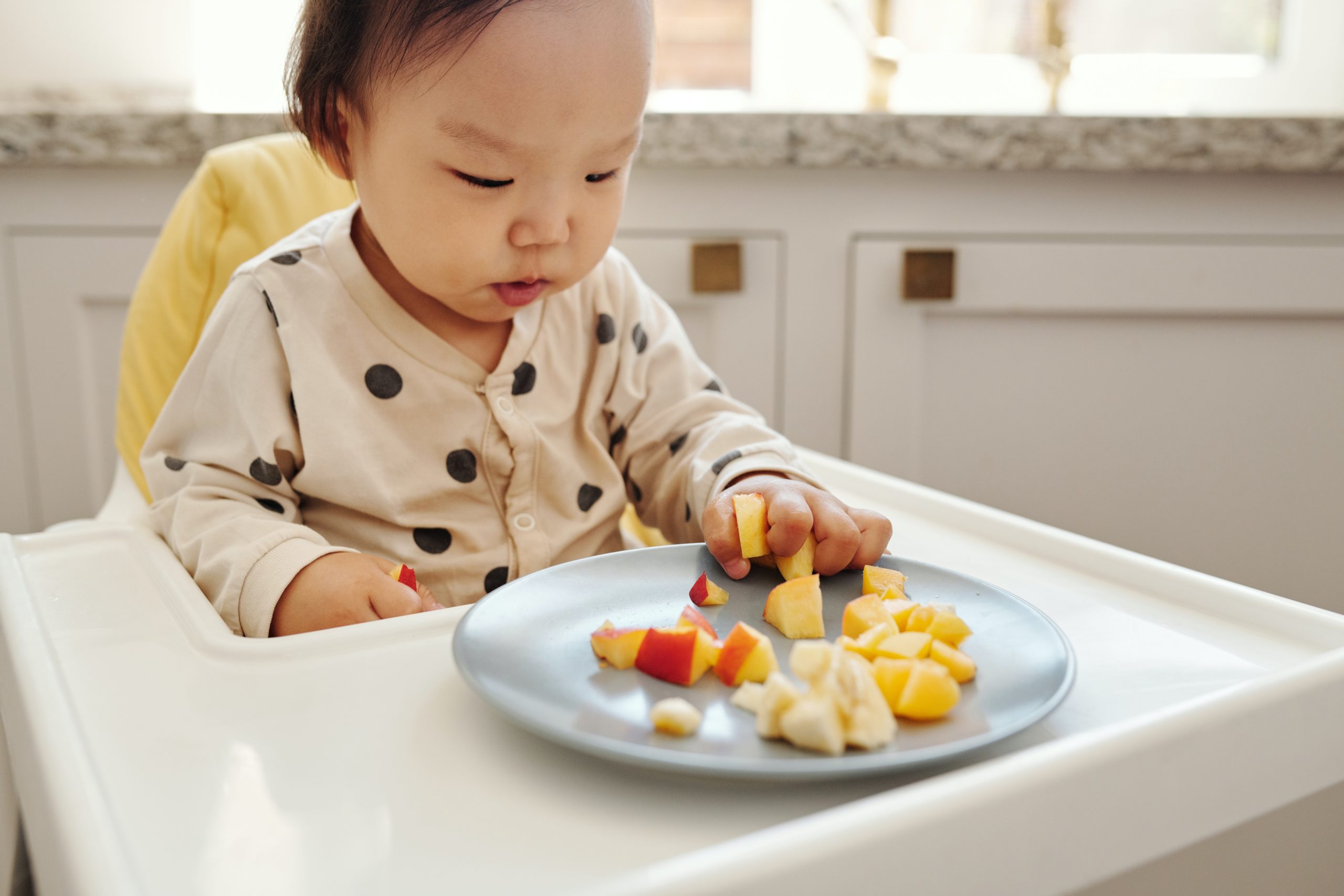 A baby eating baby food